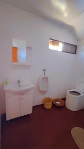 a bathroom with a sink and a toilet at Uros Utasa Lodge in Puno