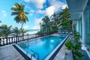 a swimming pool with a view of the ocean at Grand Samudra Hotel in Tangalle