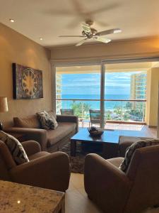 a living room with a view of the ocean at Beachfront Condo DelCanto Resort in Nuevo Vallarta