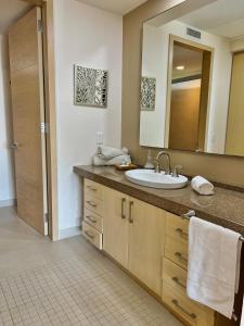 a bathroom with a sink and a mirror at Beachfront Condo DelCanto Resort in Nuevo Vallarta