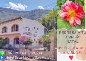 a sign in front of a building with a flower at Hotel Casa Medina in San Mateo