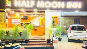 a car parked in front of a m half moon inn at Half Moon Inn in Chennai