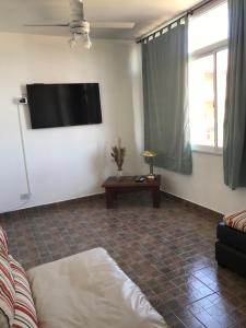 a living room with a flat screen tv on the wall at Comodo departamento centrico in San Pedro