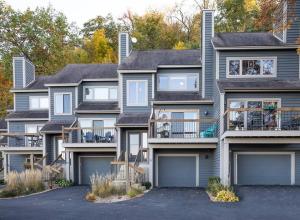 a row of houses with garages at Relaxing 2Bedroom Townhome w/Playroom & Great View in Galena