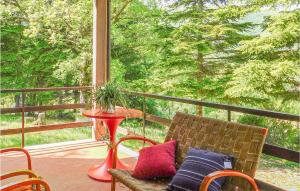 a porch with a chair and a table and a window at Amazing Home In Slorenzo Al Lfiastra in Fiume