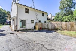 an old white house with a wooden fence at Bright Toledo Duplex, Close to Parks and Trails in Toledo