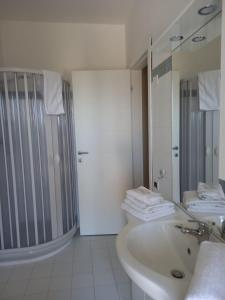 a bathroom with a sink and a shower and a mirror at Le dimore di Billa in Martella