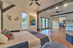 a bedroom with a large bed and a ceiling fan at Pet-Friendly Mancos Gem with Patio and Fire Pit! in Mancos