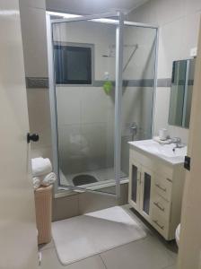 a bathroom with a shower and a sink at Bamboo Villa in Port Vila