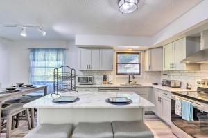 a large kitchen with white cabinets and a large island at Cozy Duplex Close to Toledo Botanical Garden in Toledo
