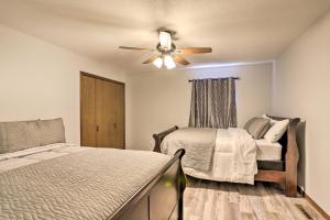 a bedroom with a bed and a ceiling fan at Cozy Duplex Close to Toledo Botanical Garden in Toledo