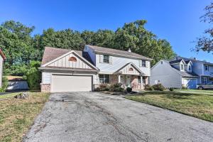 a house with a white garage on a driveway at Cozy Duplex Close to Toledo Botanical Garden in Toledo