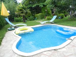 a swimming pool with two inflatables in a yard at Vila Saltanat 41 in Varna City