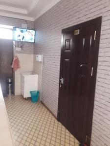 希瓦的住宿－Hotel Allanazar Ota，一间带卫生间和黑色门的浴室