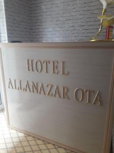 a sign for a hotel at alaminar ota at Hotel Allanazar Ota in Khiva