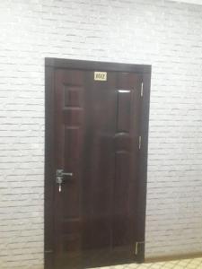 a black door with the number on it at Hotel Allanazar Ota in Khiva