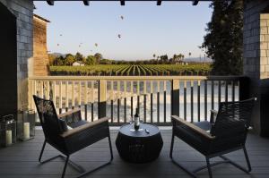 a patio area with chairs, tables, chairs and umbrellas at SENZA Hotel in Napa