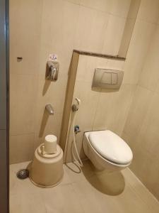 a small bathroom with a toilet and a sink at Hotel A P in Coimbatore