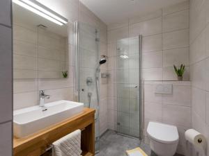 a bathroom with a shower and a sink and a toilet at Haus Dorfblick in Ellmau