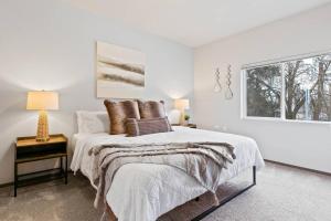 a white bedroom with a bed and a window at Full ADA Unit - 2 Bed 2 Bath Unit Near Downtown in Spokane