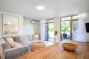 a living room with a couch and a table at The Terraces Main Beach in Byron Bay