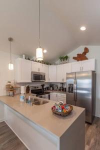 a kitchen with a counter with a bowl of food on it at Modern Decor & Style KING bed Wifi with Garage in Spokane