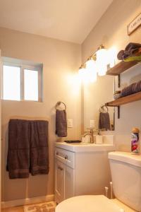 a bathroom with a sink and a toilet at Comfortable Duplex Unit - Beautiful Lake Views! in Valley