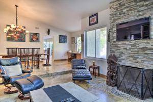 a living room with a fireplace and a tv at Carlsbad Getaway - Furnished Patio and Pool! in Carlsbad
