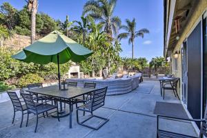 a patio with a table and chairs and an umbrella at Carlsbad Getaway - Furnished Patio and Pool! in Carlsbad
