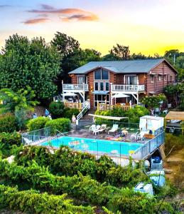 a house with a swimming pool in front of it at Vibe Naftali Estate in Ramot Naftali