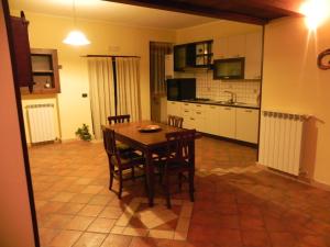 a kitchen with a table and chairs in a room at Casa Vacanze Faeto in Faeto