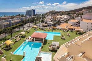 an aerial view of a resort with two pools at Apartments Palm Garden in front of the beach in Morro del Jable