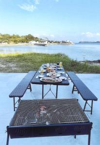 a picnic table with a grill and a table with drinks at Minshuku Hiro - Vacation STAY 84405v in Kami Amakusa