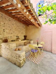 a living room with a couch and a table and chairs at Gites Lydil in Nyons