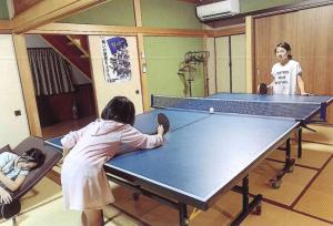 a group of people standing around a ping pong table at Minshuku Hiro - Vacation STAY 84405v in Kami Amakusa