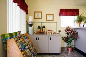 a kitchen with a counter with bottles of wine at EZ 8 Motel San Jose I in San Jose