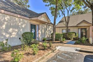 a house with a tree in the front yard at Palmetto Dunes Villa with Deck and Lagoon Views! in Hilton Head Island