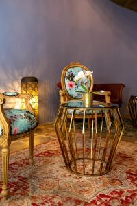 a room with two chairs and a table with a plant on it at Madama Residence in Nicosia