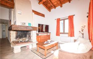 a living room with a fireplace and a couch at Nice Home In St Andrea Di Cotone With Outdoor Swimming Pool, Wifi And Private Swimming Pool in Careggia