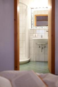 a bathroom with a sink and a mirror at Appartements Hotel-Garni Dolce Vita in Samnaun