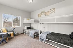a bedroom with two bunk beds and a chair at New 2 Bed 2 Bath Near Perry Dist and Downtown in Spokane