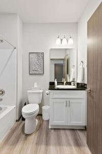 a white bathroom with a toilet and a sink at New 2 Bd 2 Bth Near Perry Dist and Downtown in Spokane
