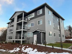 a large apartment building with a garage at New 2 Bd 2 Bth Near Perry Dist and Downtown in Spokane