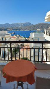 a table on a balcony with a view of the ocean at Amaryllis Hotel in Karpathos