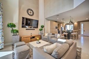 a living room with a couch and a clock on the wall at Upscale Townhome Close to Walt Disney World! in Orlando