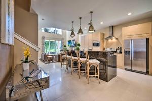 a kitchen with a bar with chairs and a counter top at Upscale Townhome Close to Walt Disney World! in Orlando