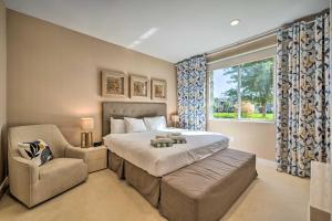 a bedroom with a bed and a chair and a window at Upscale Townhome Close to Walt Disney World! in Orlando