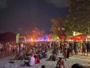 a large crowd of people on a beach at night at Haadrin Fellini Home in Haad Rin