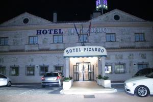 a hotel with cars parked in front of it at Hotel Pizarro in Humanes de Madrid