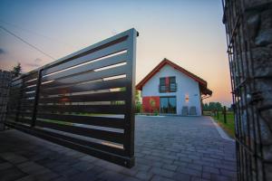 a large fence in front of a house at Na Skraju Raju in Zator